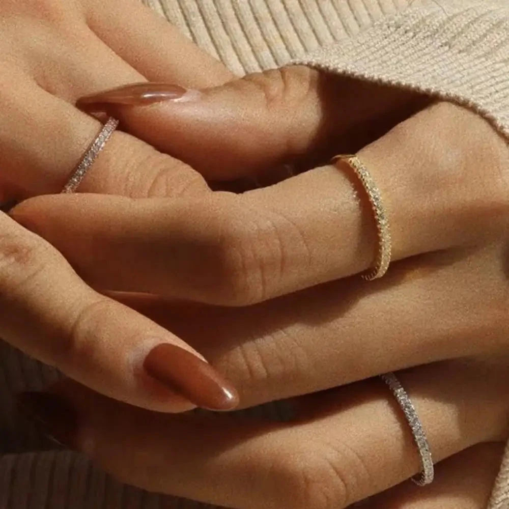 Minimalist full eternity band crafted from stainless steel with 18K gold plating, encrusted with shimmering cubic zirconia pavé all around. Hypoallergenic, water- and tarnish-resistant—perfect for effortless stacking or wearing solo for timeless sparkle.