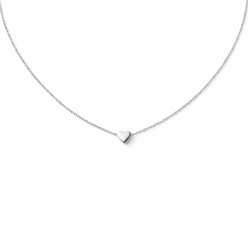 Silver heart-shaped pendant necklace on a white background