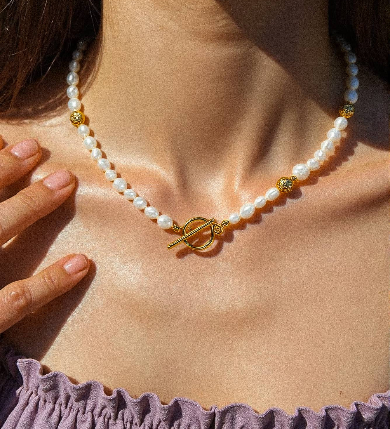 Choker necklace featuring natural baroque pearls with organically varied shapes, finished with an 18K gold-plated clasp. Measures 16 inches with a 2-inch extender. Hypoallergenic, water- and tarnish-resistant—perfect for adding timeless elegance and modern sophistication to any jewellery rotation