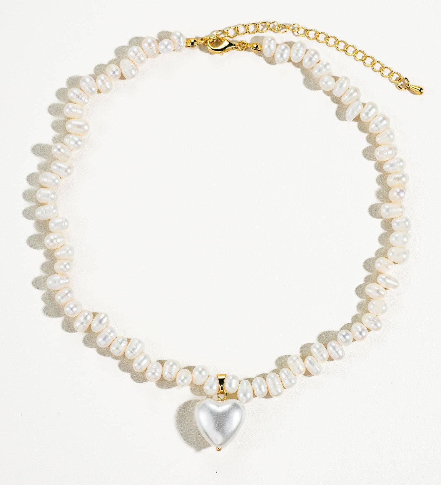 Elegant choker necklace crafted from 18K gold-plated stainless steel, featuring a natural baroque pearl heart pendant that sits delicately at the collarbone. Hypoallergenic, water- and tarnish-resistant—perfect for adding a timeless statement of love and sophistication to any look.