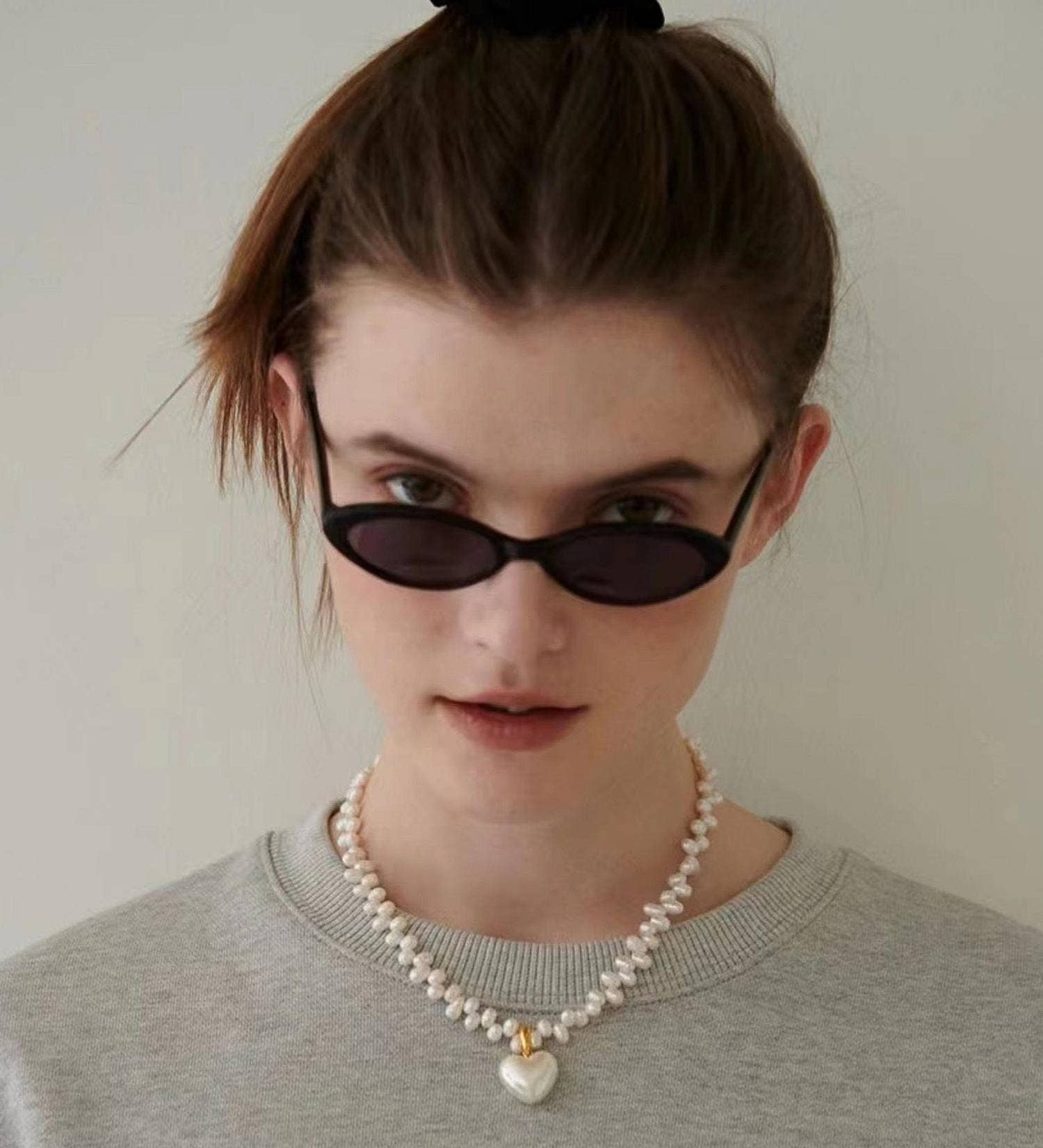 Elegant choker necklace crafted from 18K gold-plated stainless steel, featuring a natural baroque pearl heart pendant that sits delicately at the collarbone. Hypoallergenic, water- and tarnish-resistant—perfect for adding a timeless statement of love and sophistication to any look.