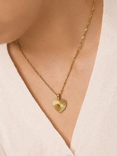Classic heart pendant necklace crafted from 18K gold-plated stainless steel, featuring a refined chain measuring 16.14 inches with a 1.97-inch extender. Romantic, minimalist, and timeless—perfect for adding tender elegance to any look. Hypoallergenic, water- and tarnish-resistant.