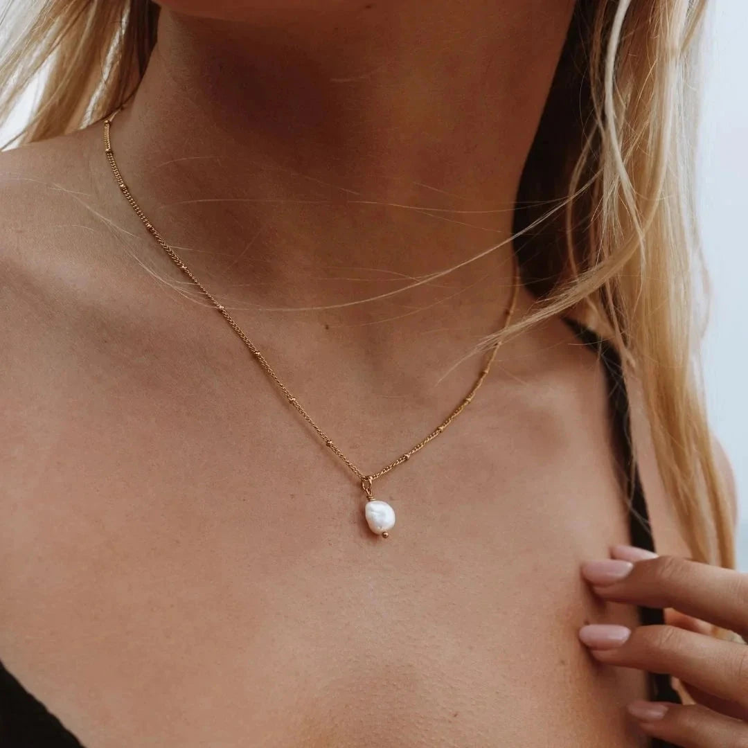 Modern classic necklace crafted from 18K gold-plated stainless steel, featuring a naturally formed freshwater baroque pearl pendant with a unique organic shape. Hypoallergenic, water- and tarnish-resistant—perfect for elevating any look with timeless elegance and natural beauty. 