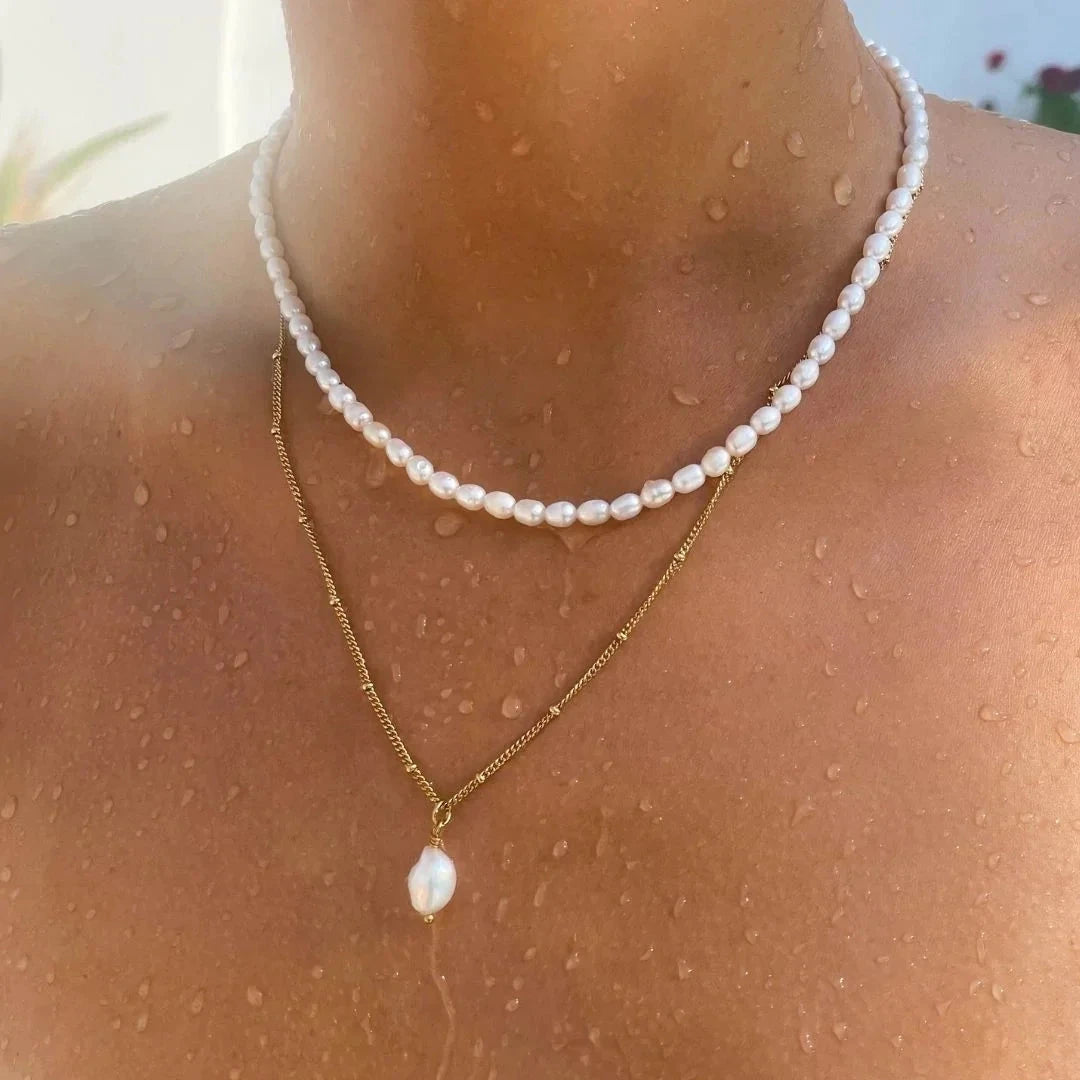 Modern classic necklace crafted from 18K gold-plated stainless steel, featuring a naturally formed freshwater baroque pearl pendant with a unique organic shape. Hypoallergenic, water- and tarnish-resistant—perfect for elevating any look with timeless elegance and natural beauty.