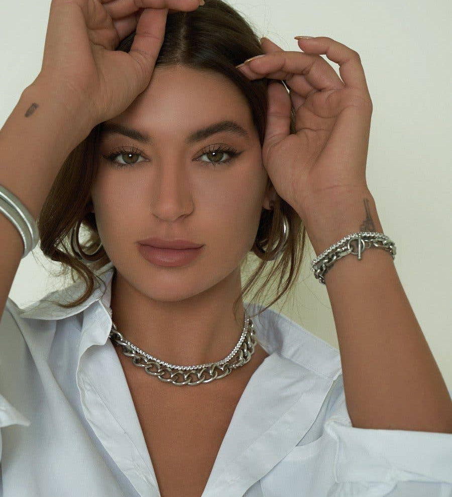 Classic tennis necklace crafted from brass with premium 18K gold plating, featuring brilliant cubic zirconia for timeless sparkle. Hypoallergenic, water- and tarnish-resistant—perfect for wearing solo or layered to add effortless sophistication to any look.