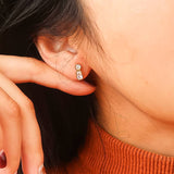 Dainty stud earrings featuring brilliant-cut cubic zirconia set in a polished 18K gold-plated stainless steel frame. Measuring 0.40 x 0.15 inches, these hypoallergenic, water- and tarnish-resistant studs offer minimalist sparkle—ideal solo or stacked.