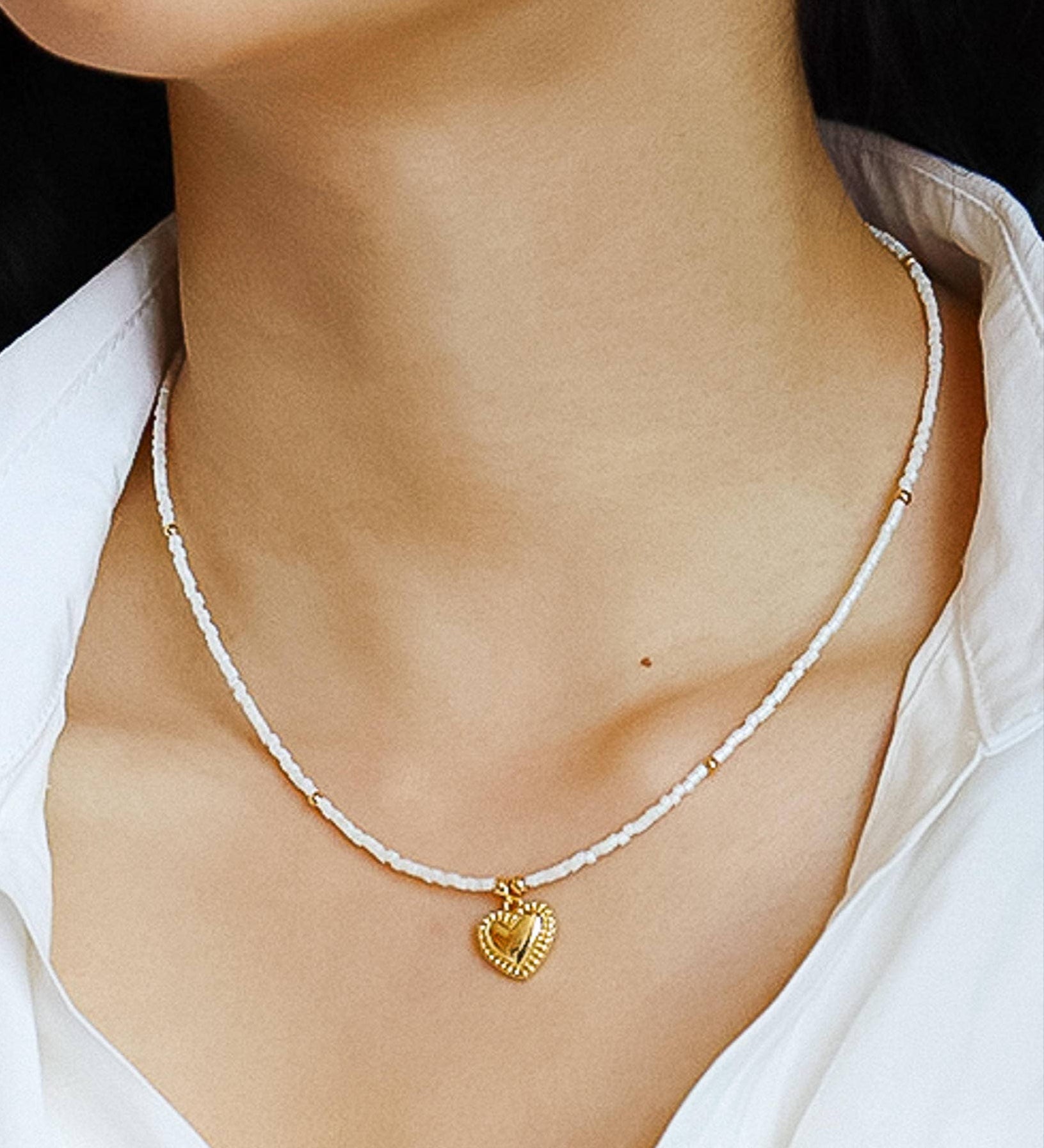 Delicate necklace crafted from a brass base with premium 18K gold plating, featuring a handmade beaded chain and polished heart-shaped pendant. Hypoallergenic, water- and tarnish-resistant—perfect for adding a charming, romantic touch to any look.