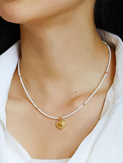 Delicate necklace crafted from a brass base with premium 18K gold plating, featuring a handmade beaded chain and polished heart-shaped pendant. Hypoallergenic, water- and tarnish-resistant—perfect for adding a charming, romantic touch to any look.