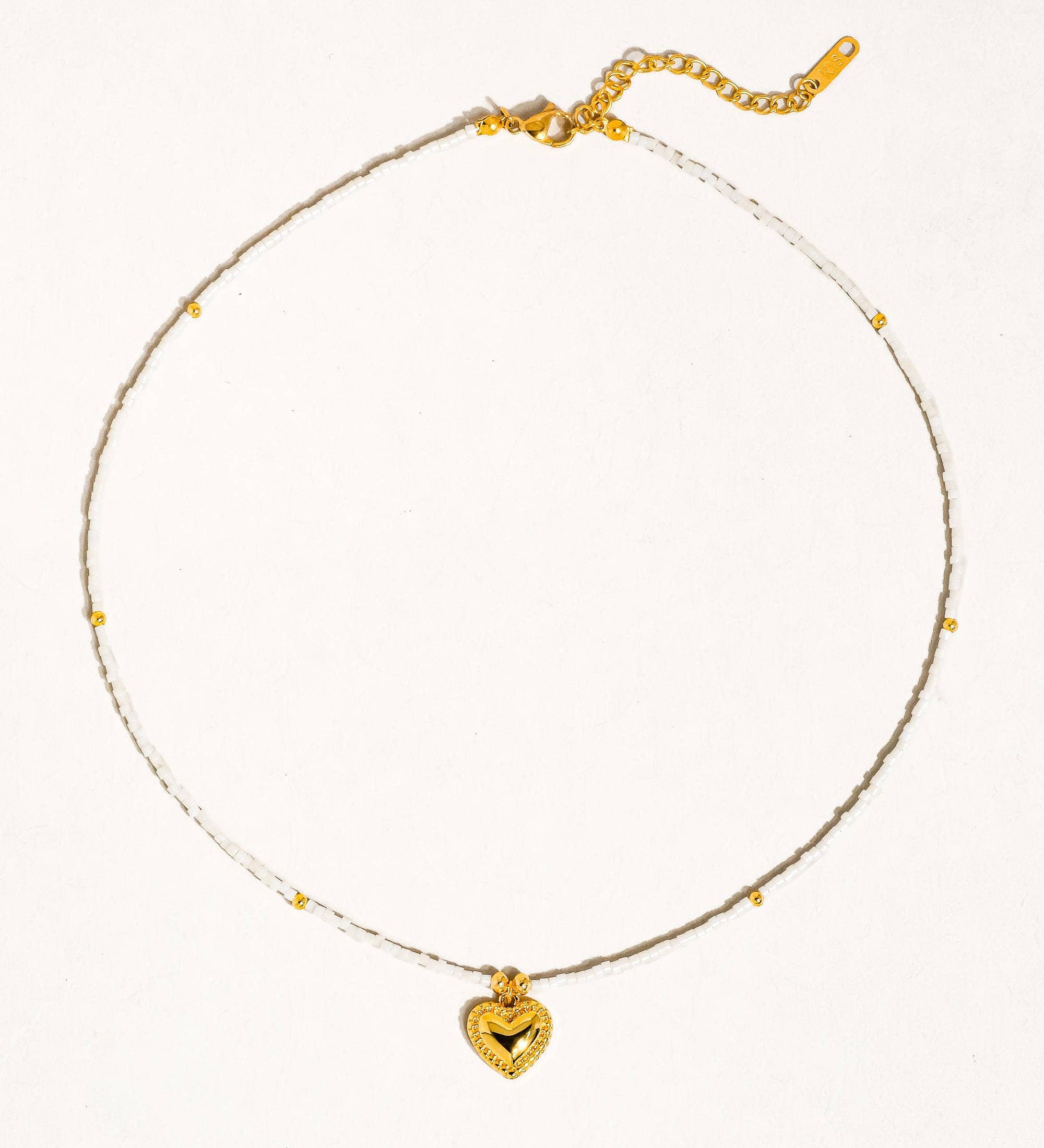 Delicate necklace crafted from a brass base with premium 18K gold plating, featuring a handmade beaded chain and polished heart-shaped pendant. Hypoallergenic, water- and tarnish-resistant—perfect for adding a charming, romantic touch to any look.