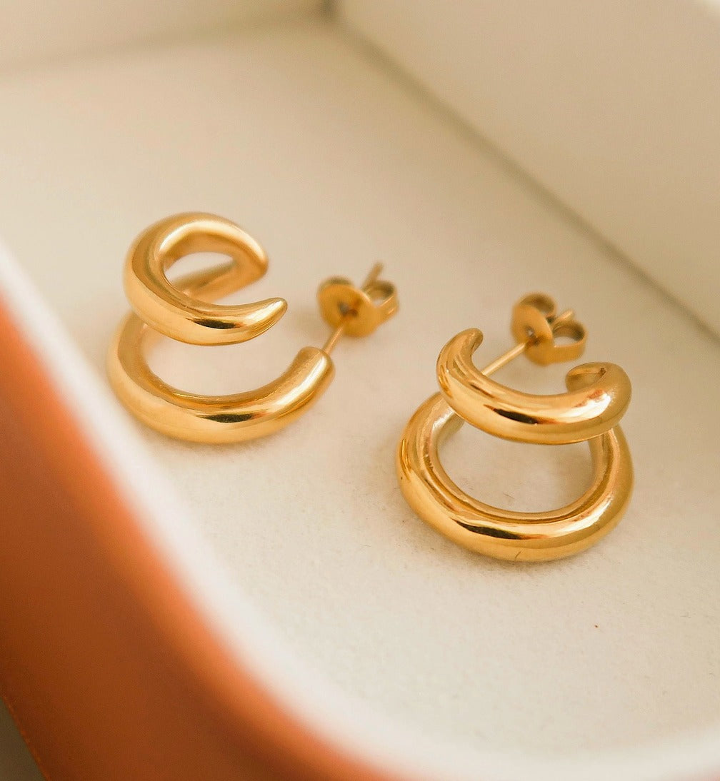Modern double hoop earrings crafted from premium stainless steel, featuring interlocking double-C design for a structured look. Diameter 0.6 inches. Contemporary, versatile, and chic—perfect for elevating any outfit with bold yet refined style. Hypoallergenic, water- and tarnish-resistant.