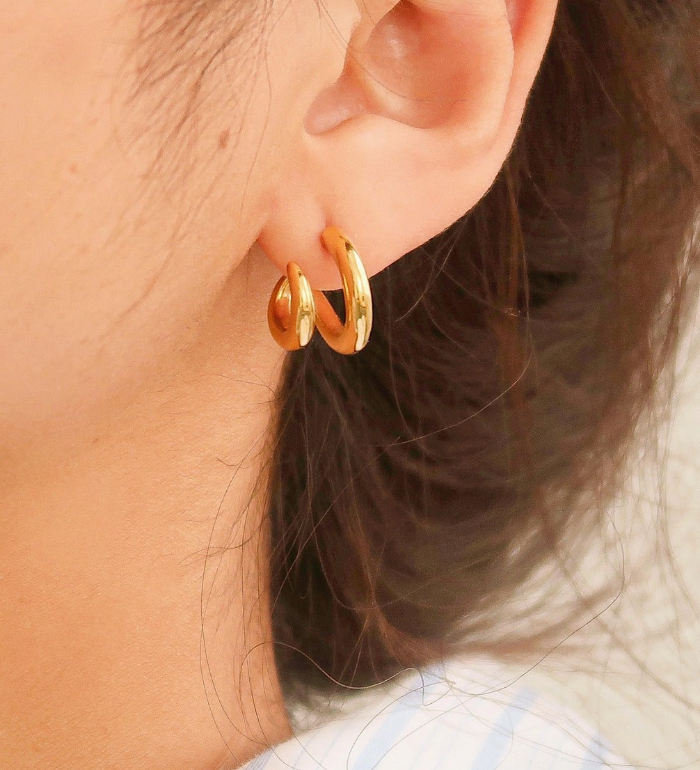 Modern double hoop earrings crafted from premium stainless steel, featuring interlocking double-C design for a structured look. Diameter 0.6 inches. Contemporary, versatile, and chic—perfect for elevating any outfit with bold yet refined style. Hypoallergenic, water- and tarnish-resistant.