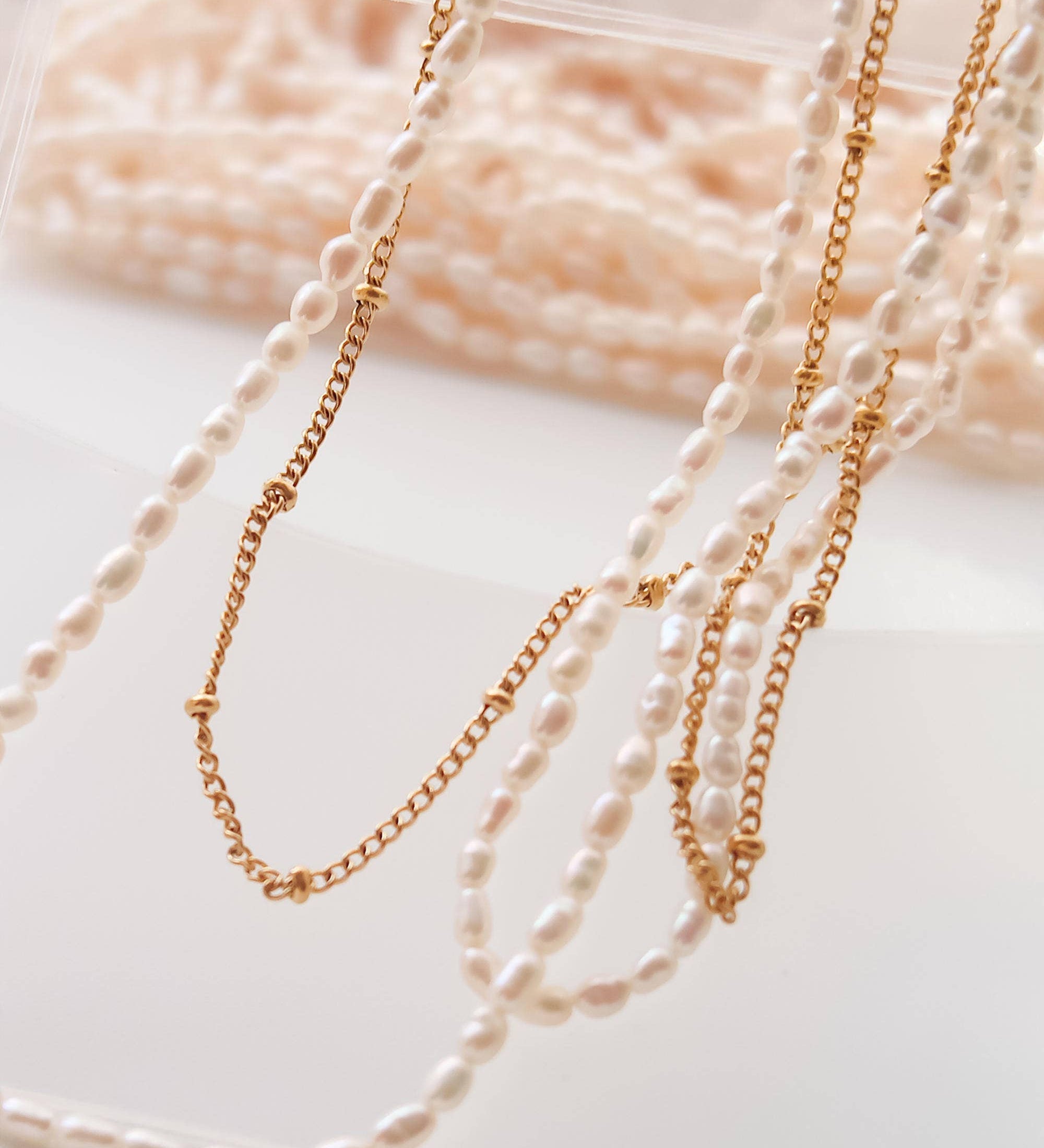 Dual-layered necklace crafted from 18K gold-plated stainless steel, featuring delicate freshwater pearl detailing. Measures approx. 15 inches with a 2-inch extender. Hypoallergenic, water- and tarnish-resistant—perfect for blending modern layering with timeless elegance.