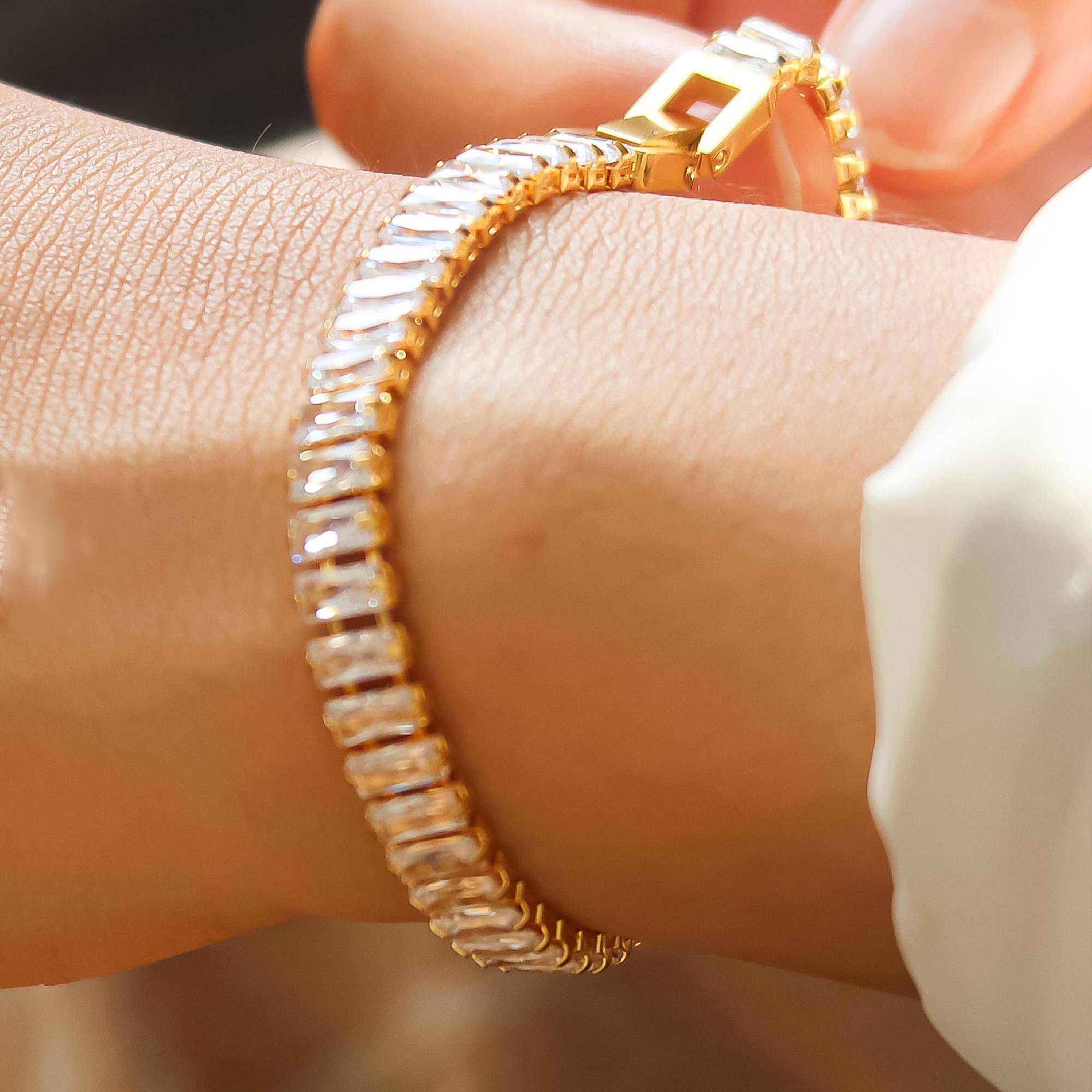 Elegant bracelet crafted from stainless steel with 18K gold plating, featuring high-quality cubic zirconia for brilliant sparkle. Chain length 6.8 inches with extender for adjustable fit. Hypoallergenic, water- and tarnish-resistant—perfect for adding instant shine and effortless elegance to any stack.