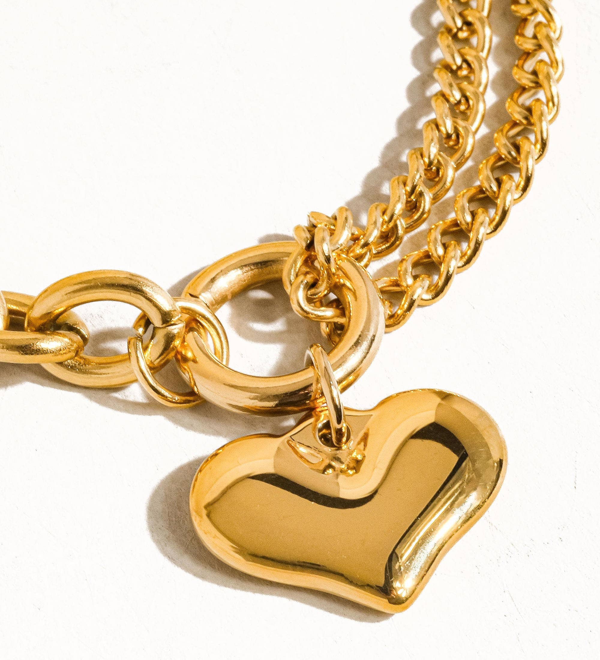 Delicate chain bracelet featuring polished heart-shaped links measuring 0.7 x 0.7 inches, crafted from 18K gold-plated stainless steel. Chain length 6 inches with a 1-inch extender. Non-tarnish, hypoallergenic, lead- and nickel-free, and water-resistant—perfect for adding romantic elegance to any look.