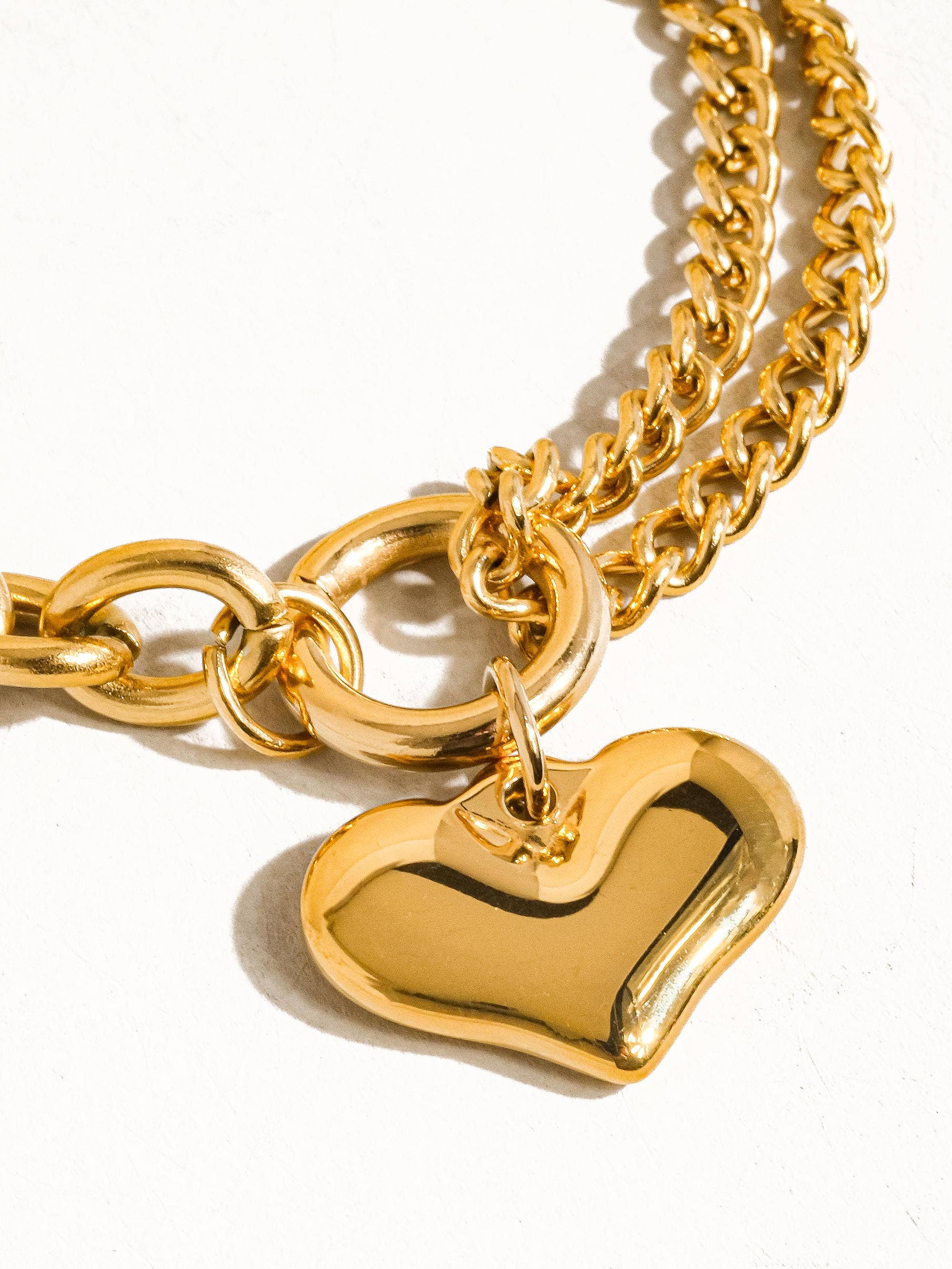 Delicate chain bracelet featuring polished heart-shaped links measuring 0.7 x 0.7 inches, crafted from 18K gold-plated stainless steel. Chain length 6 inches with a 1-inch extender. Non-tarnish, hypoallergenic, lead- and nickel-free, and water-resistant—perfect for adding romantic elegance to any look.