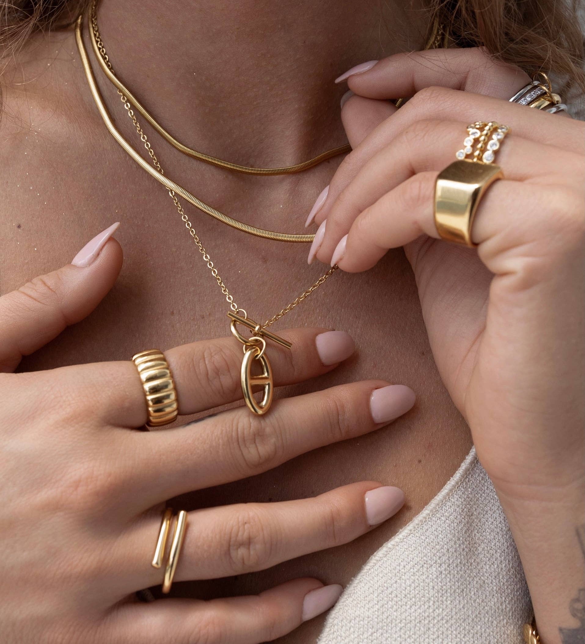 Bold and polished statement ring with a minimalist silhouette, crafted from 18K gold-plated stainless steel. US size 7. Hypoallergenic, water- and tarnish-resistant—an effortlessly powerful piece that adds refined edge to any look.