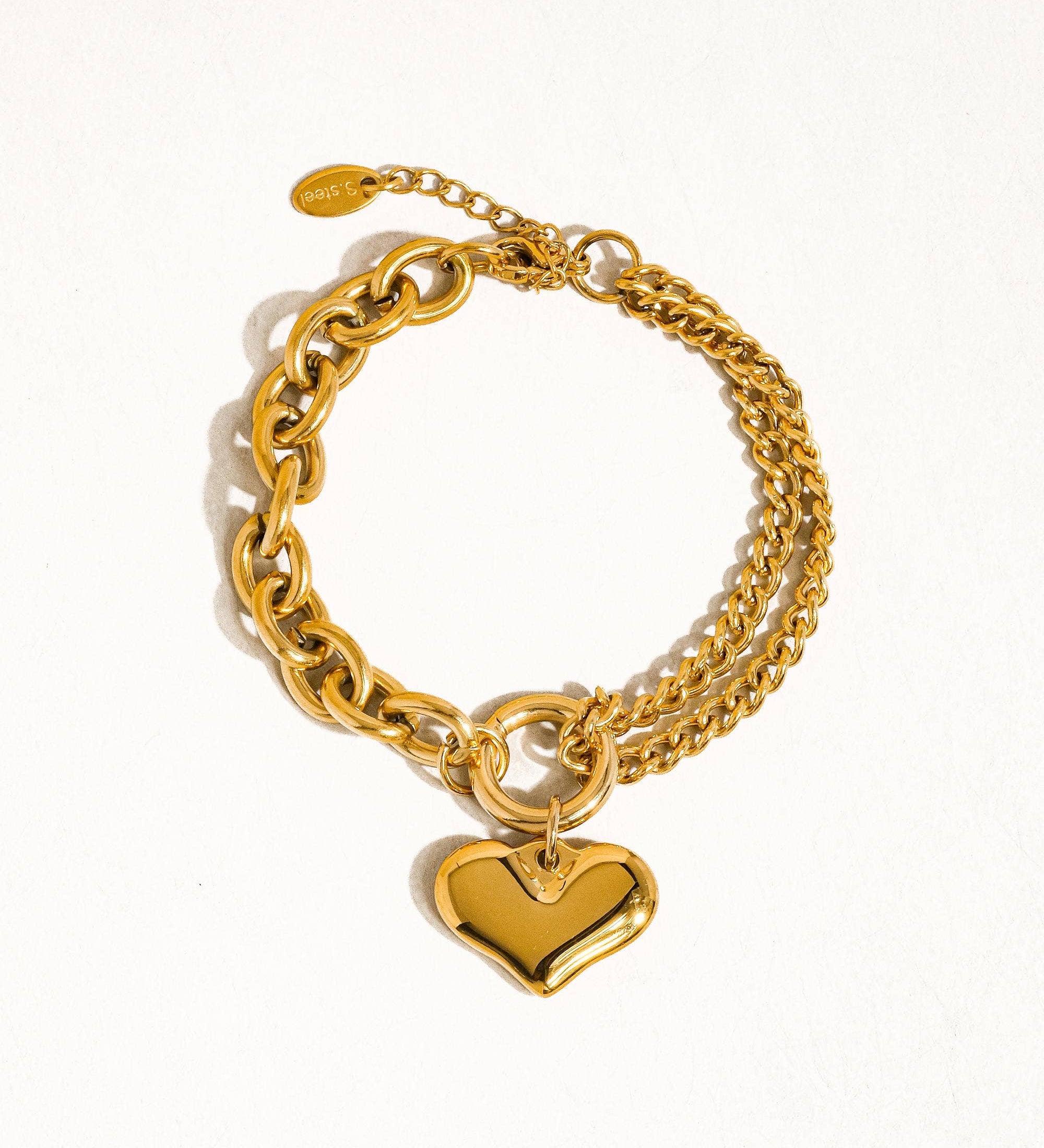 Delicate chain bracelet featuring polished heart-shaped links measuring 0.7 x 0.7 inches, crafted from 18K gold-plated stainless steel. Chain length 6 inches with a 1-inch extender. Non-tarnish, hypoallergenic, lead- and nickel-free, and water-resistant—perfect for adding romantic elegance to any look.