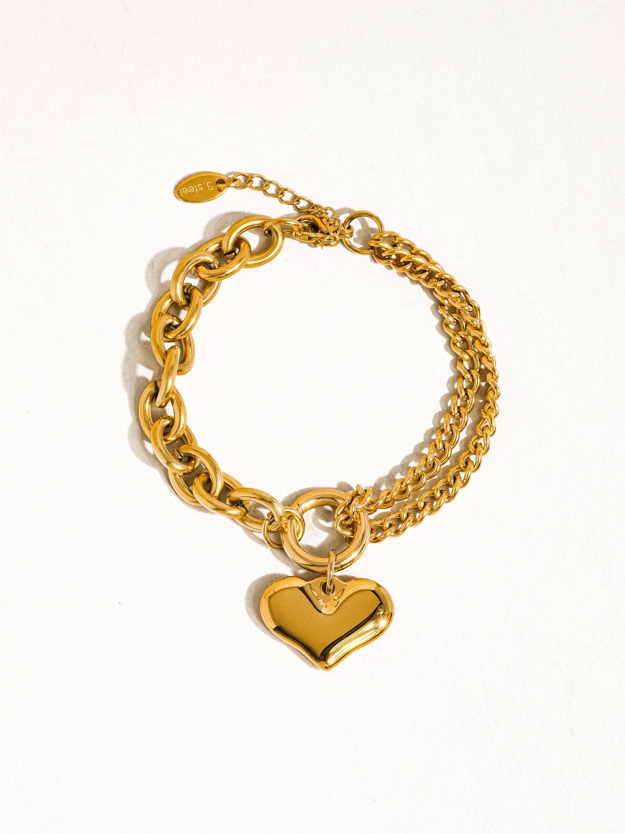 Delicate chain bracelet featuring polished heart-shaped links measuring 0.7 x 0.7 inches, crafted from 18K gold-plated stainless steel. Chain length 6 inches with a 1-inch extender. Non-tarnish, hypoallergenic, lead- and nickel-free, and water-resistant—perfect for adding romantic elegance to any look.