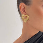 Sculpted heart stud earrings crafted from 18K gold PVD-plated stainless steel, featuring a unique textured design for added dimension and charm. Hypoallergenic, water- and tarnish-resistant—perfect for making a bold, romantic statement.
