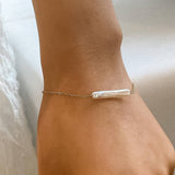 Elegant 18K gold-plated bracelet featuring a lustrous freshwater pearl pendant (1.22 inches) on a 6.69-inch stainless steel chain with a 1.96-inch extender. Non-tarnish, hypoallergenic, water-resistant, and free from lead and nickel—perfect for refined, everyday luxury or meaningful gifting.
