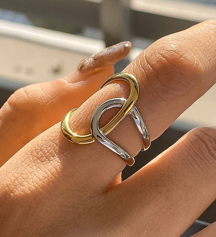 Contemporary statement ring crafted from stainless steel with 18K gold and silver plating, featuring an organic abstract shape in a modern two-tone finish. Hypoallergenic, nickel-free, water- and tarnish-resistant—perfect for adding artistic contrast and bold style to any look.
