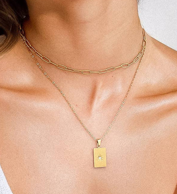 Layered necklace crafted from premium 18K gold-plated stainless steel, featuring a cosmic rhinestone pendant and celestial-inspired design. Hypoallergenic, water- and tarnish-resistant—perfect for adding mystical edge and elegant sparkle to any look.