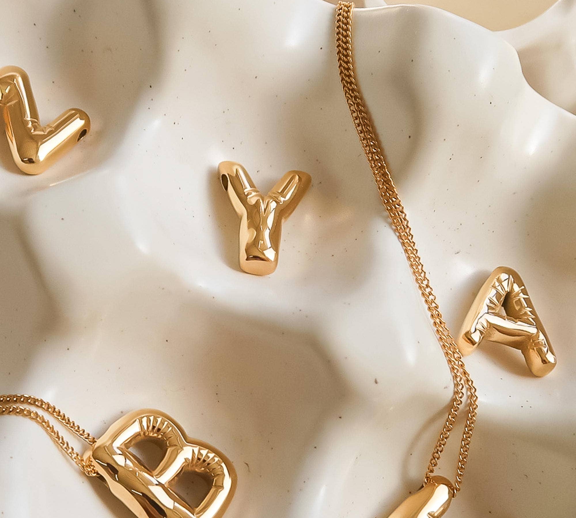 Playful necklace crafted from premium stainless steel with 18K gold plating, featuring a balloon-style alphabet letter pendant (0.8 inch). Chain length 16 inches plus 2-inch extender. Hypoallergenic, water- and tarnish-resistant—perfect for adding a personal and whimsical touch to any look