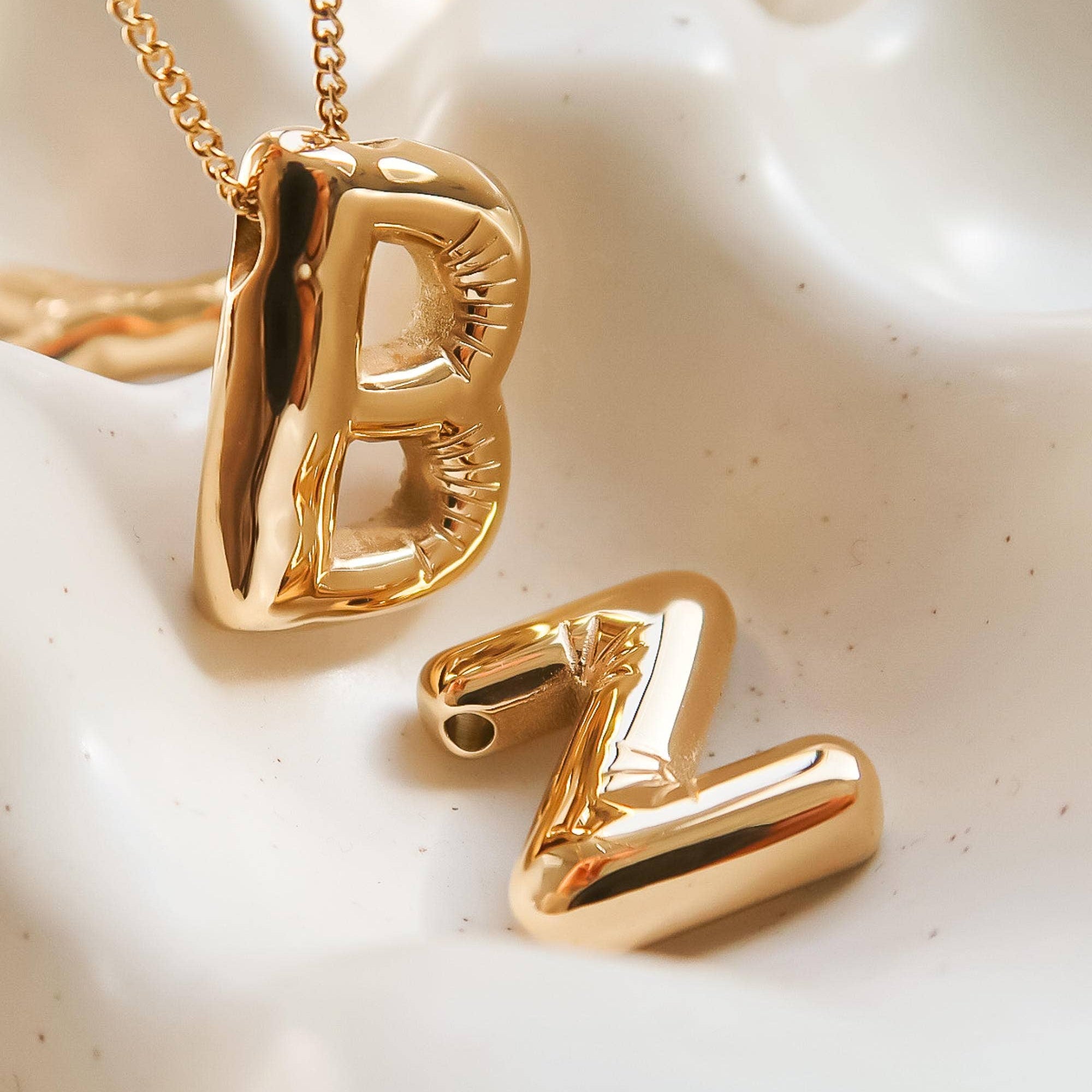 Playful necklace crafted from premium stainless steel with 18K gold plating, featuring a balloon-style alphabet letter pendant (0.8 inch). Chain length 16 inches plus 2-inch extender. Hypoallergenic, water- and tarnish-resistant—perfect for adding a personal and whimsical touch to any look