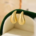 Mini droplet huggie earrings crafted from stainless steel with elegant 18K gold plating. Subtle yet eye-catching 20mm length adds a touch of glamour and sophistication. Hypoallergenic, water- and tarnish-resistant—perfect for elevating any outfit with refined shine.