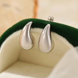 Mini droplet huggie earrings crafted from stainless steel with elegant 18K gold plating. Subtle yet eye-catching 20mm length adds a touch of glamour and sophistication. Hypoallergenic, water- and tarnish-resistant—perfect for elevating any outfit with refined shine.