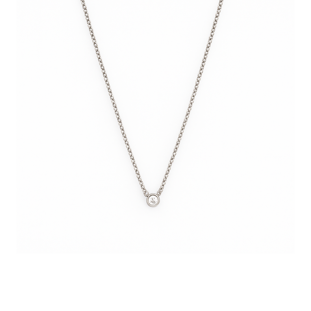 Silver necklace with a small round pendant on a white background