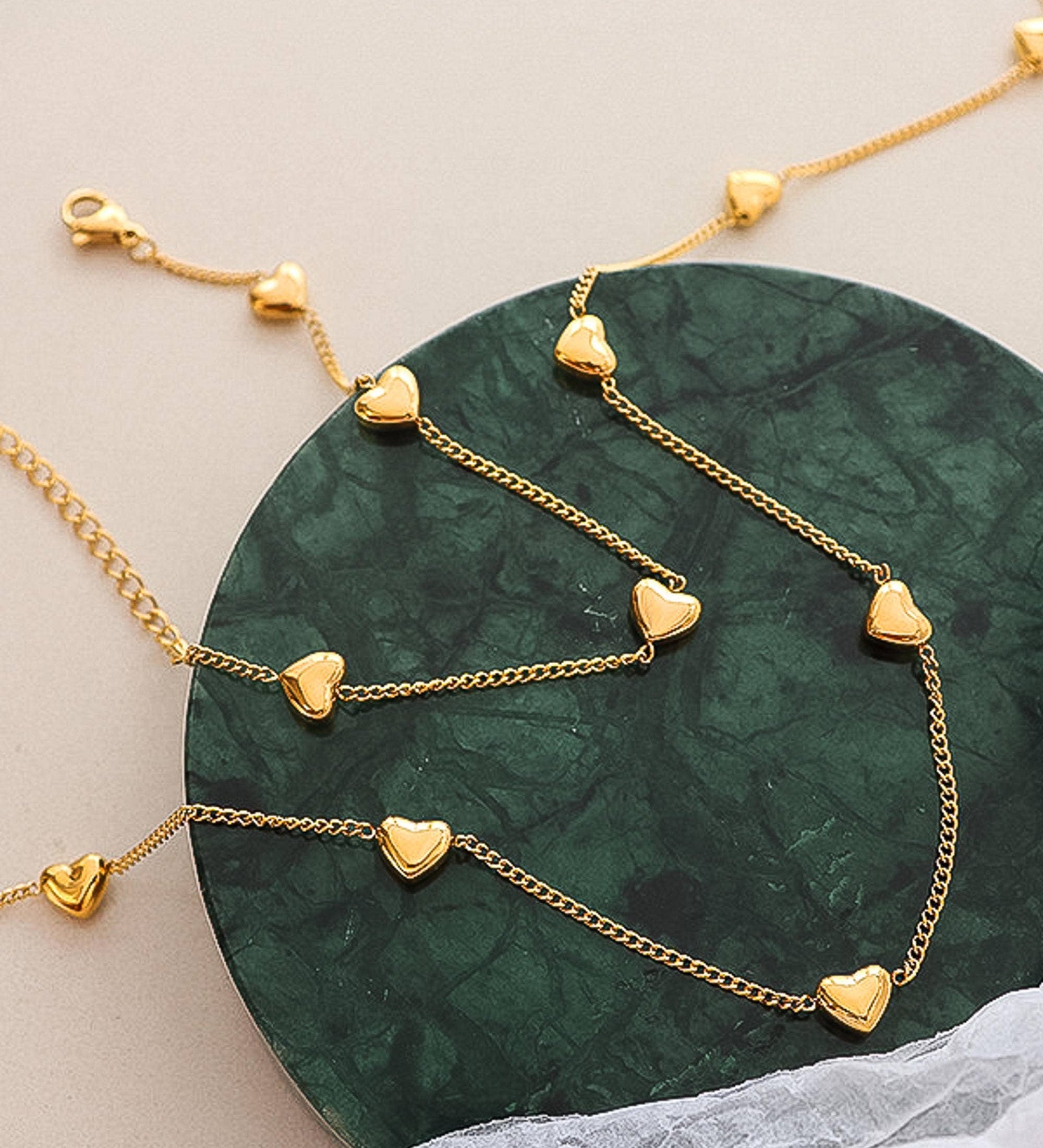 Dainty necklace crafted from 18K gold-plated titanium steel, featuring a petite heart charm on a fine adjustable chain measuring 13.7 inches. Hypoallergenic, nickel-free, tarnish- and water-resistant—perfect for adding subtle romance to any look.