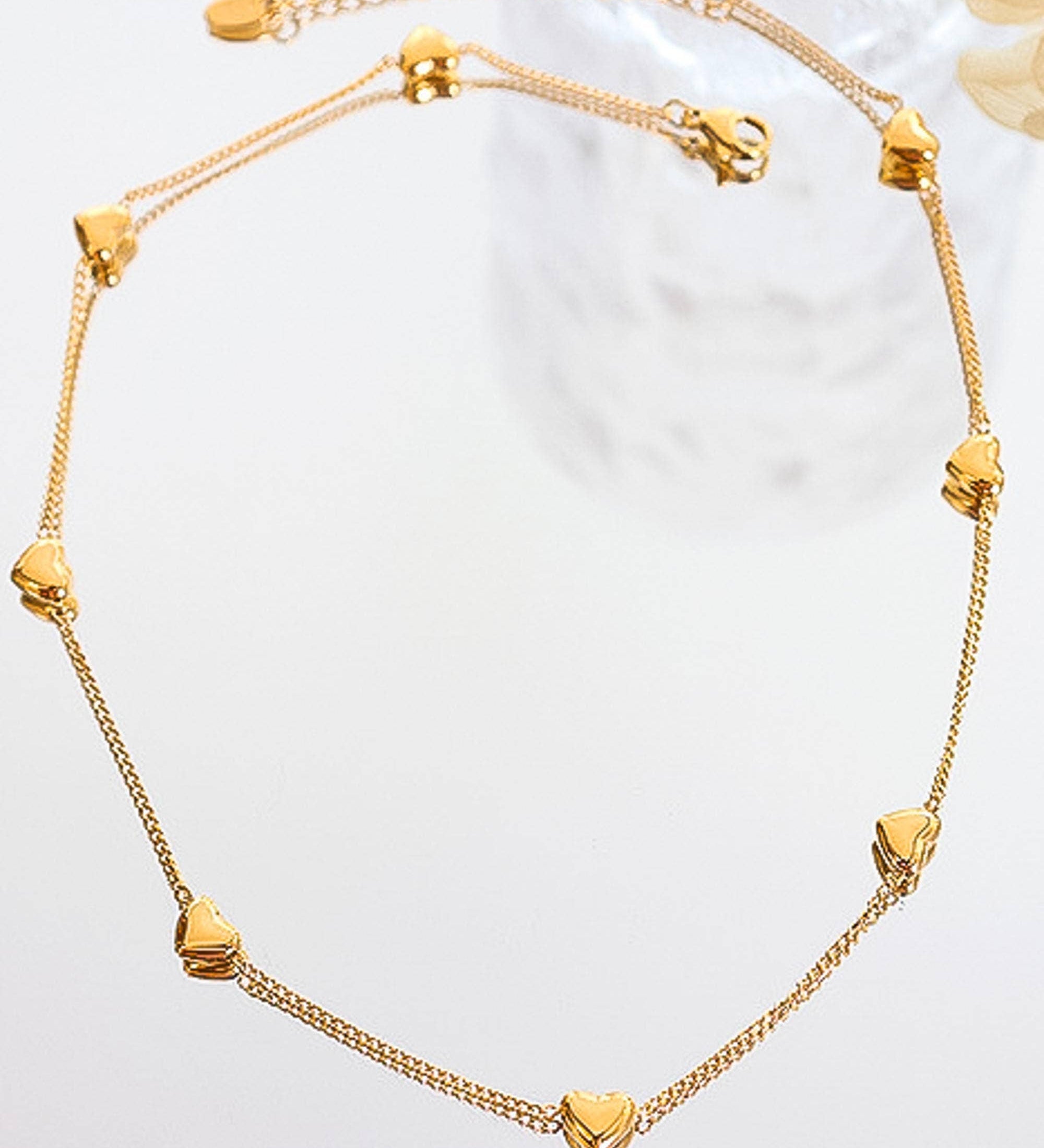 Dainty necklace crafted from 18K gold-plated titanium steel, featuring a petite heart charm on a fine adjustable chain measuring 13.7 inches. Hypoallergenic, nickel-free, tarnish- and water-resistant—perfect for adding subtle romance to any look.