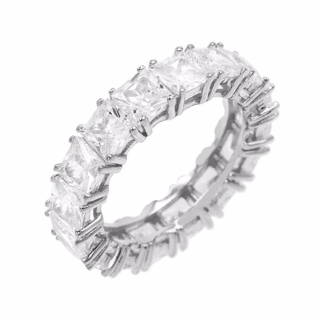 Sleek sterling silver band ring featuring clear princess-cut cubic zirconia stones for subtle sparkle. 5 mm wide design perfect for stacking or wearing solo to add a touch of everyday glam. Hypoallergenic, water- and tarnish-resistant.