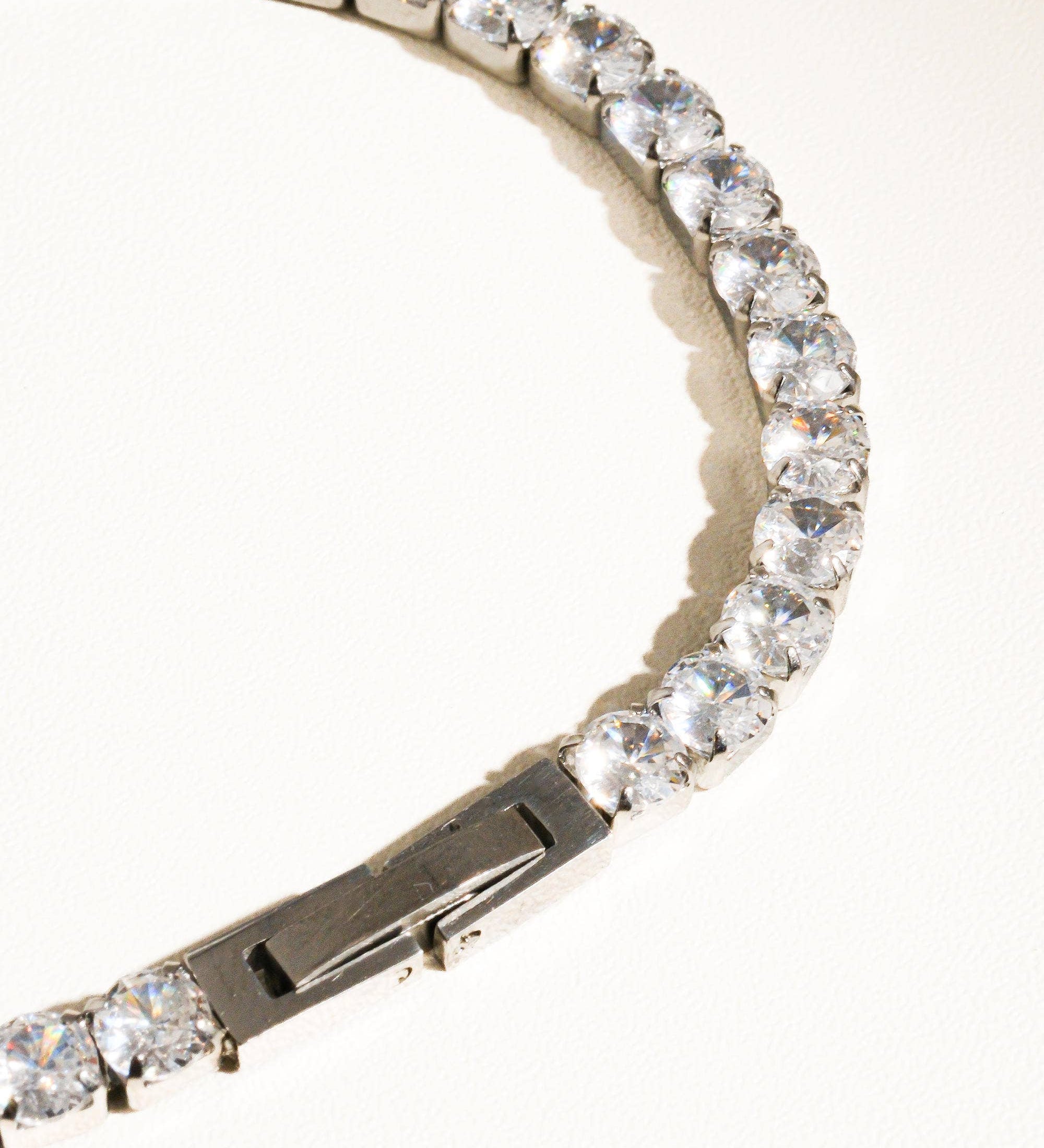 Elegant non-tarnish rhinestone bracelet made from stainless steel, featuring sparkling cubic zirconia stones along a 6-inch chain. Designed to be water-resistant, hypoallergenic, and free from lead and nickel, with a sleek and dressy style perfect for special occasions.