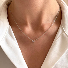 Rhodium-plated sterling silver, hypoallergenic & tarnish-resistant, featuring a sparkling zirconium stone on model