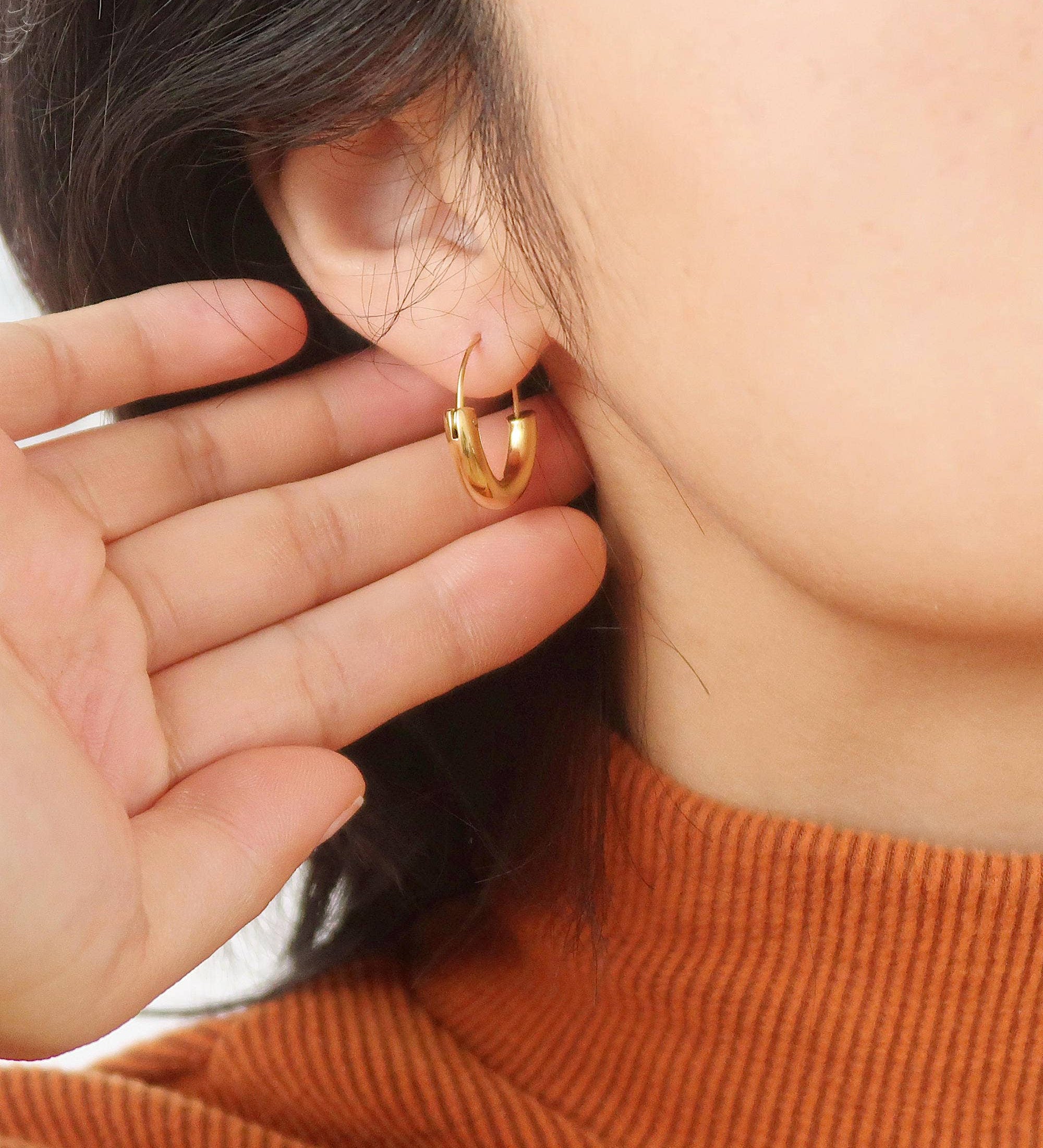 Sleek U-shaped hoop earrings with a softly polished finish, crafted for a modern twist on a timeless silhouette. Made from hypoallergenic, water- and tarnish-resistant materials—perfect for adding effortless sophistication to both casual and dressy looks.