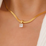 Sleek snake chain necklace crafted from premium stainless steel with 18K gold plating, featuring a square-cut cubic zirconia pendant (0.25” / 0.64cm) for refined sparkle. Hypoallergenic, water- and tarnish-resistant—perfect for effortless, modern elegance.
