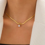 Sleek snake chain necklace crafted from premium stainless steel with 18K gold plating, featuring a square-cut cubic zirconia pendant (0.25” / 0.64cm) for refined sparkle. Hypoallergenic, water- and tarnish-resistant—perfect for effortless, modern elegance.