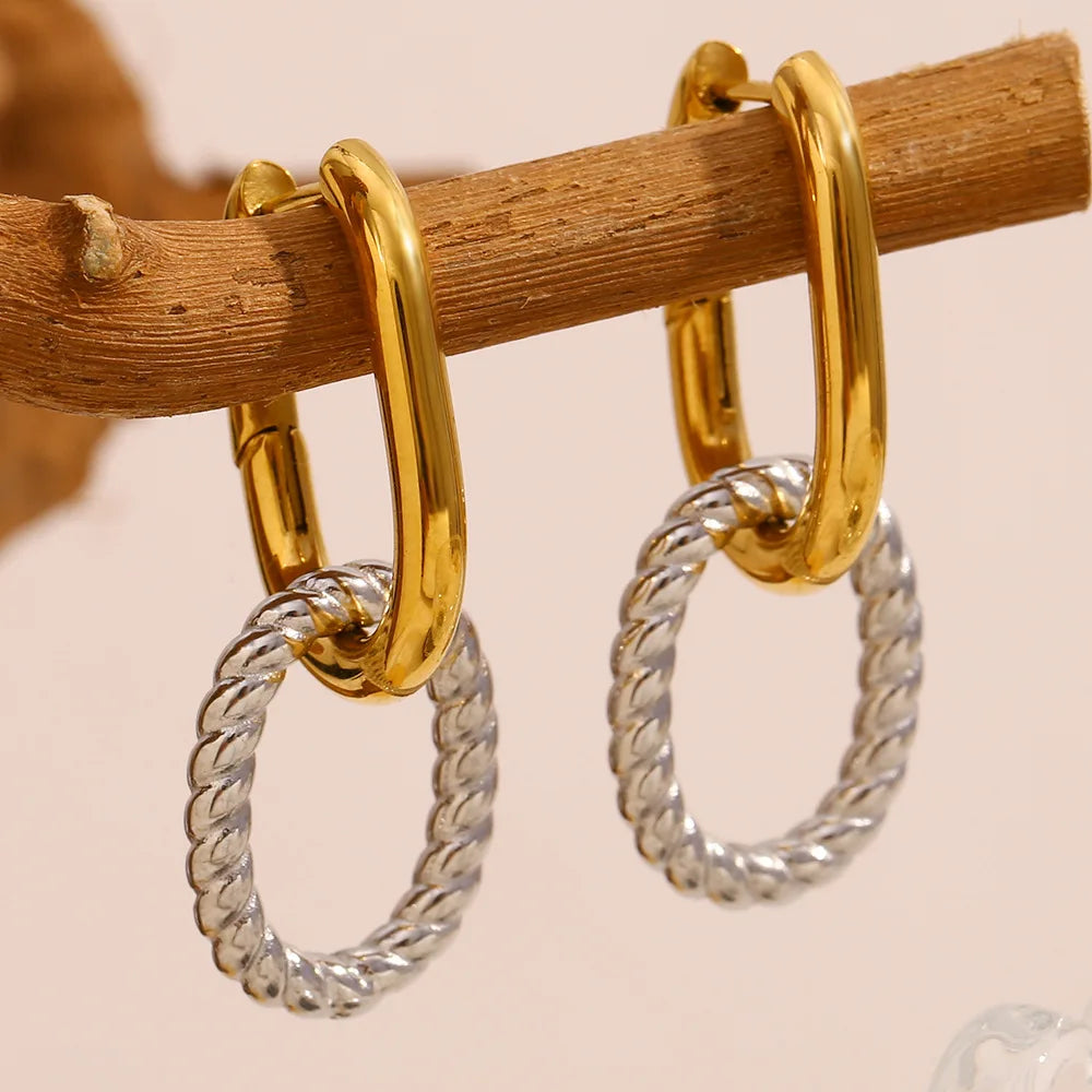 Statement hoop earrings crafted from premium stainless steel with gold and silver plating, featuring bold double-chain details anchored on classic dual-tone hoops. Hypoallergenic, water- and tarnish-resistant—perfect for adding modern sophistication to everyday looks.