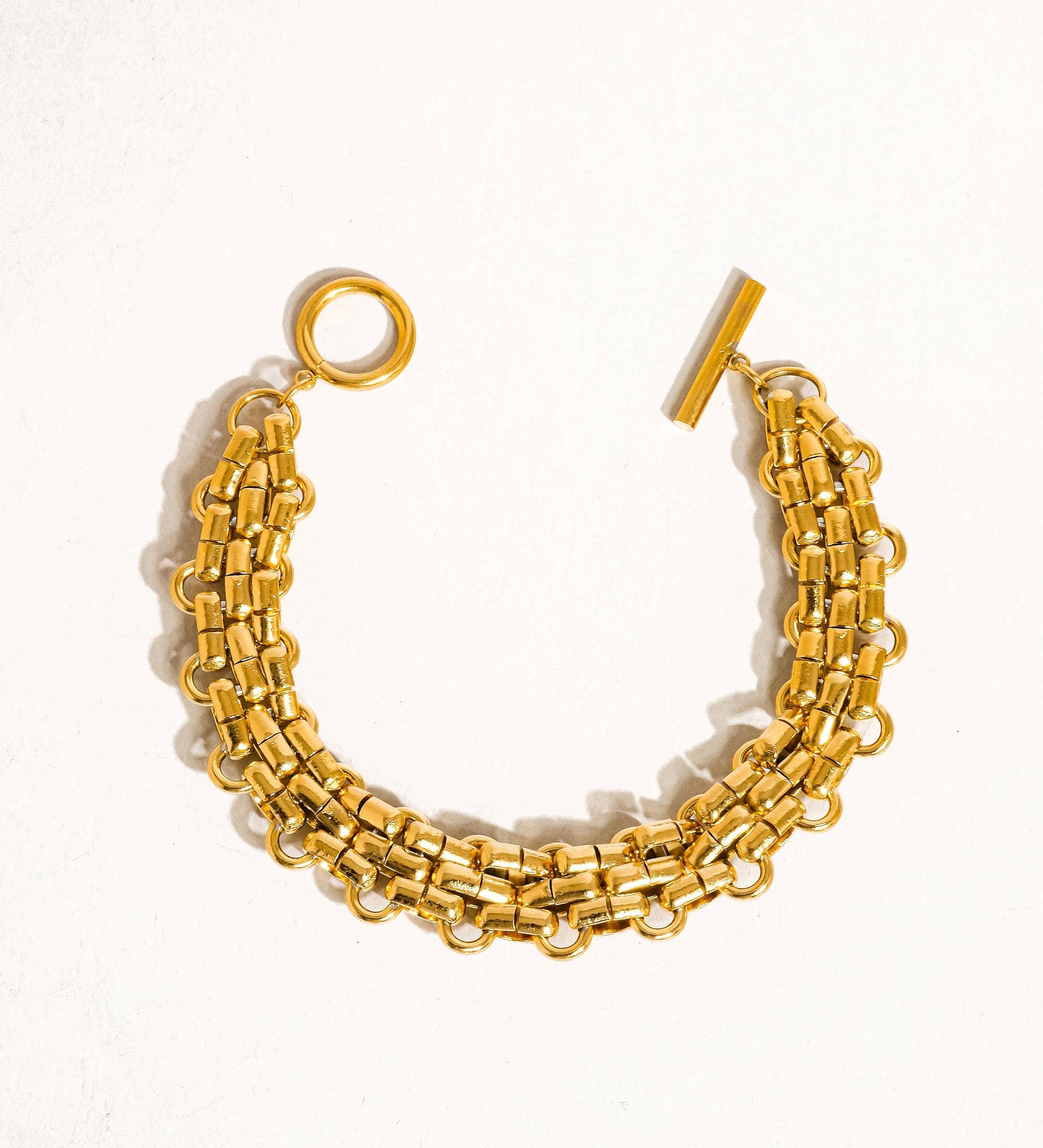 Striking bracelet crafted from stainless steel with 18K gold plating, featuring a bold weave pattern for a contemporary, textured look. Chain length 7.09 inches. Hypoallergenic, water- and tarnish-resistant—perfect for adding luxe sophistication and strength to any ensemble.