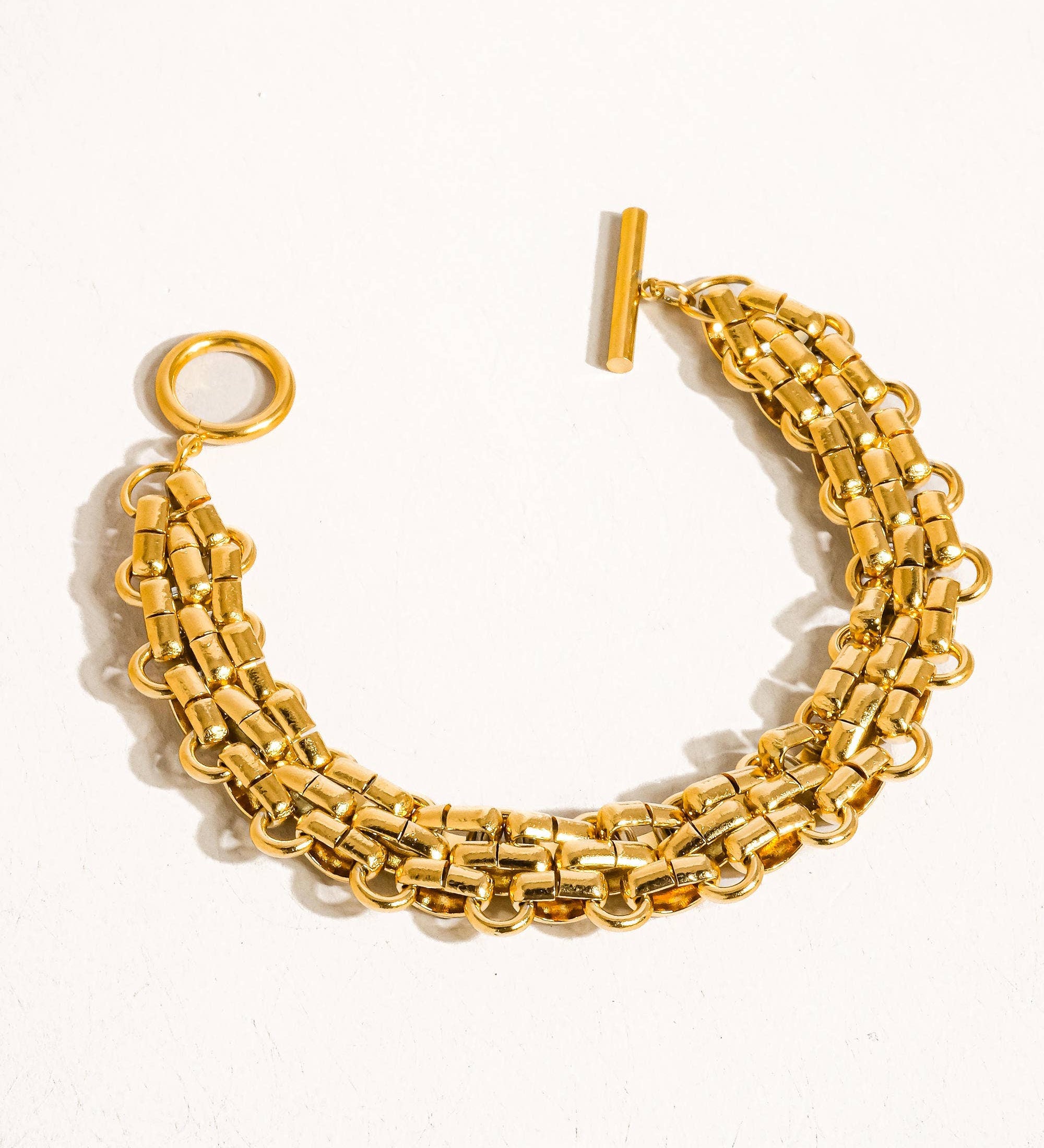 Striking bracelet crafted from stainless steel with 18K gold plating, featuring a bold weave pattern for a contemporary, textured look. Chain length 7.09 inches. Hypoallergenic, water- and tarnish-resistant—perfect for adding luxe sophistication and strength to any ensemble.
