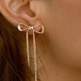 Statement earrings with a bold heart-shaped top and flowing chain tassels for graceful movement. Crafted from 18K gold-plated stainless steel, measuring 1.06 x 3.07 inches. Hypoallergenic, water- and tarnish-resistant—romantic and radiant, ideal for special occasions or elevating casual looks.