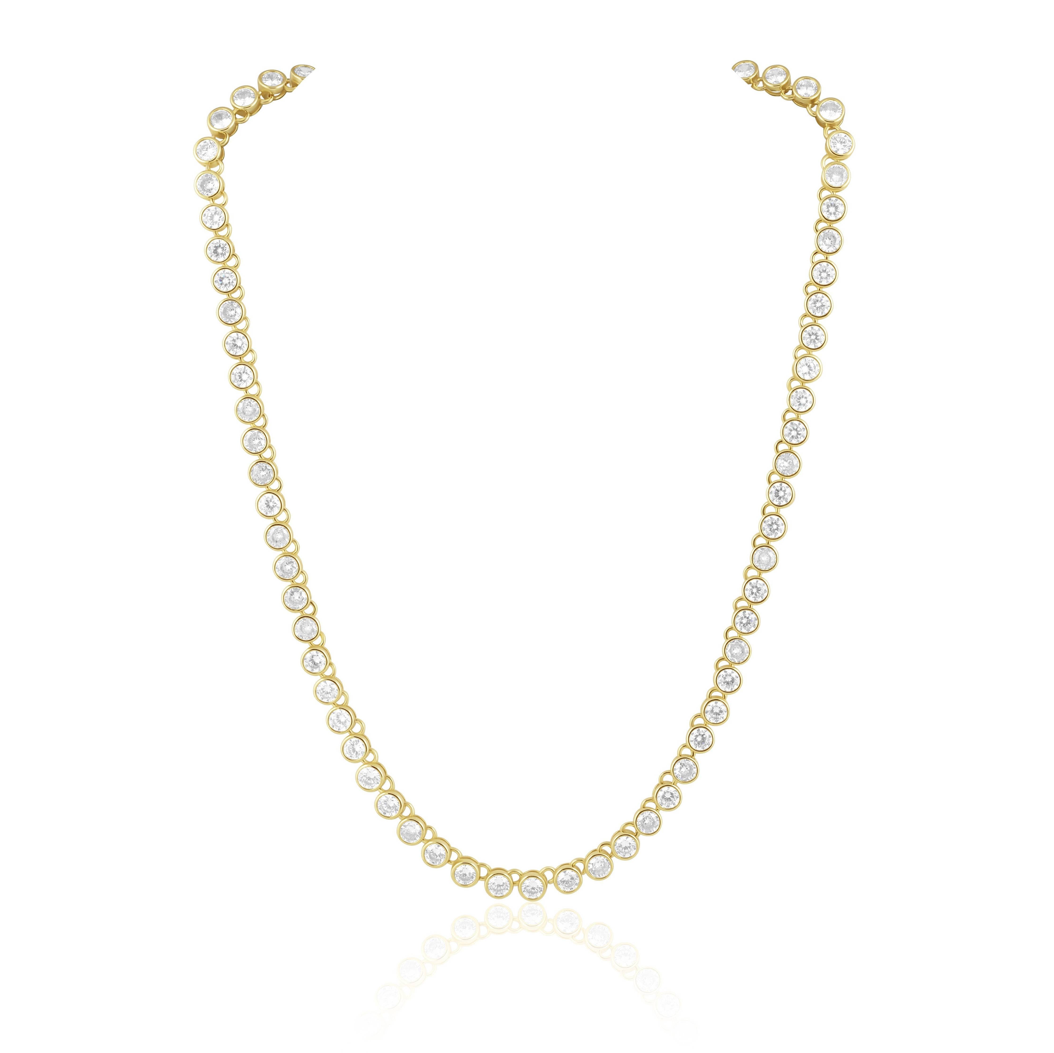 Elegant tennis necklace featuring a continuous line of sparkling cubic zirconia stones set in 18K gold-plated stainless steel. Designed for timeless sparkle with a modern edge, this hypoallergenic, water- and tarnish-resistant piece is perfect worn solo or layered for added glamour.