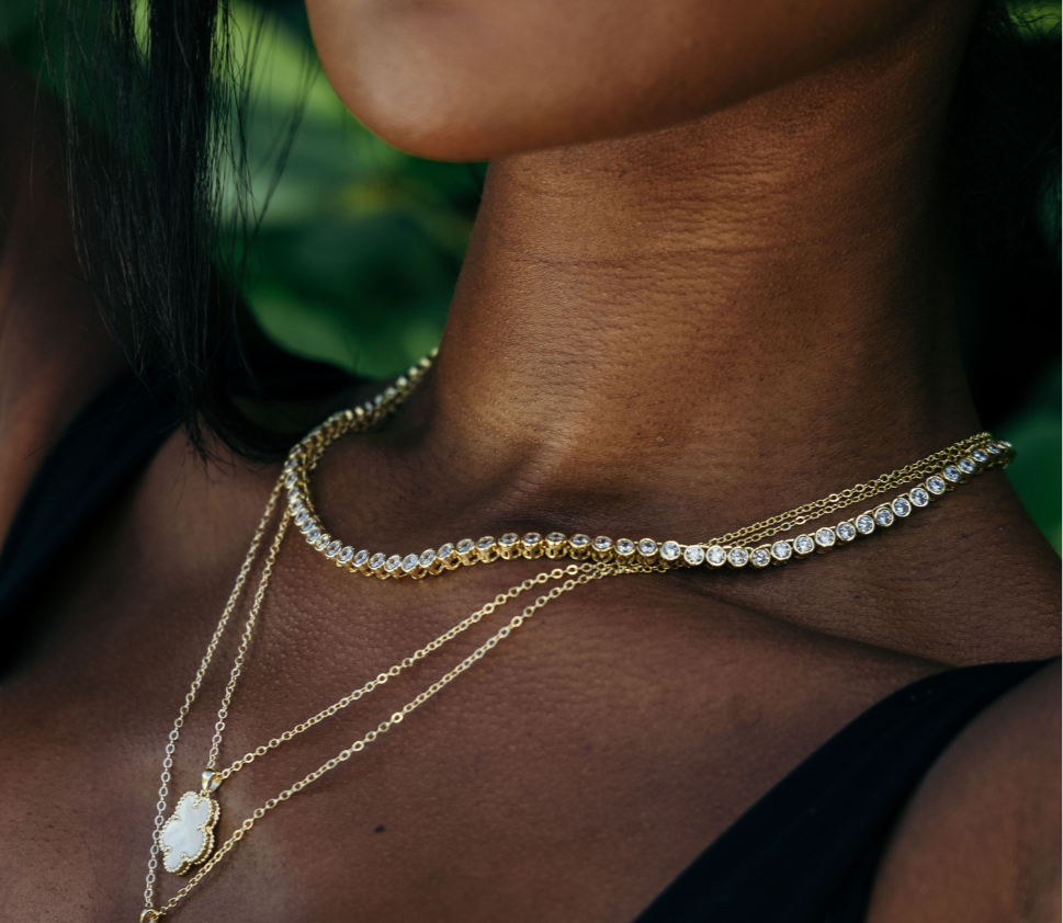 Elegant tennis necklace featuring a continuous line of sparkling cubic zirconia stones set in 18K gold-plated stainless steel. Designed for timeless sparkle with a modern edge, this hypoallergenic, water- and tarnish-resistant piece is perfect worn solo or layered for added glamour.
