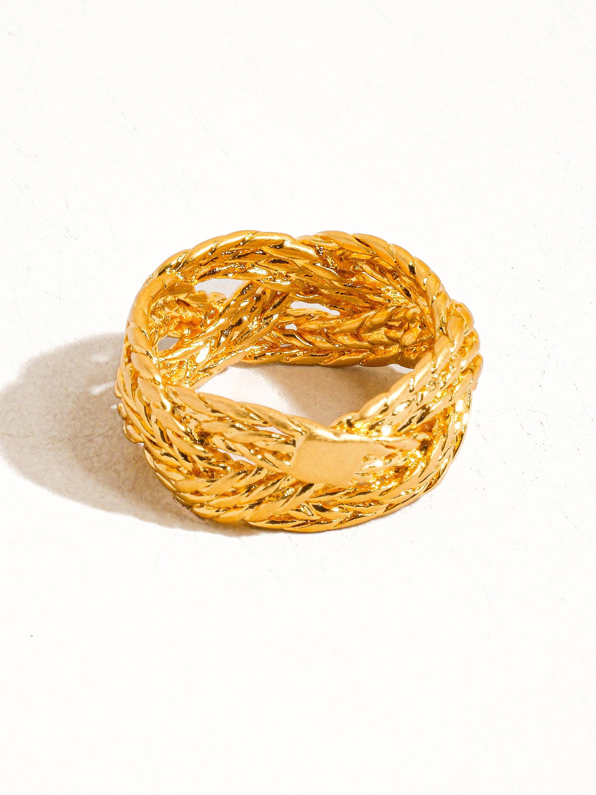Sculptural vintage-inspired ring with a polished gold twist design, crafted from 18K gold-plated brass. Sized at US 7 (0.682" diameter), this hypoallergenic, water- and tarnish-resistant piece blends timeless charm with everyday wearability.