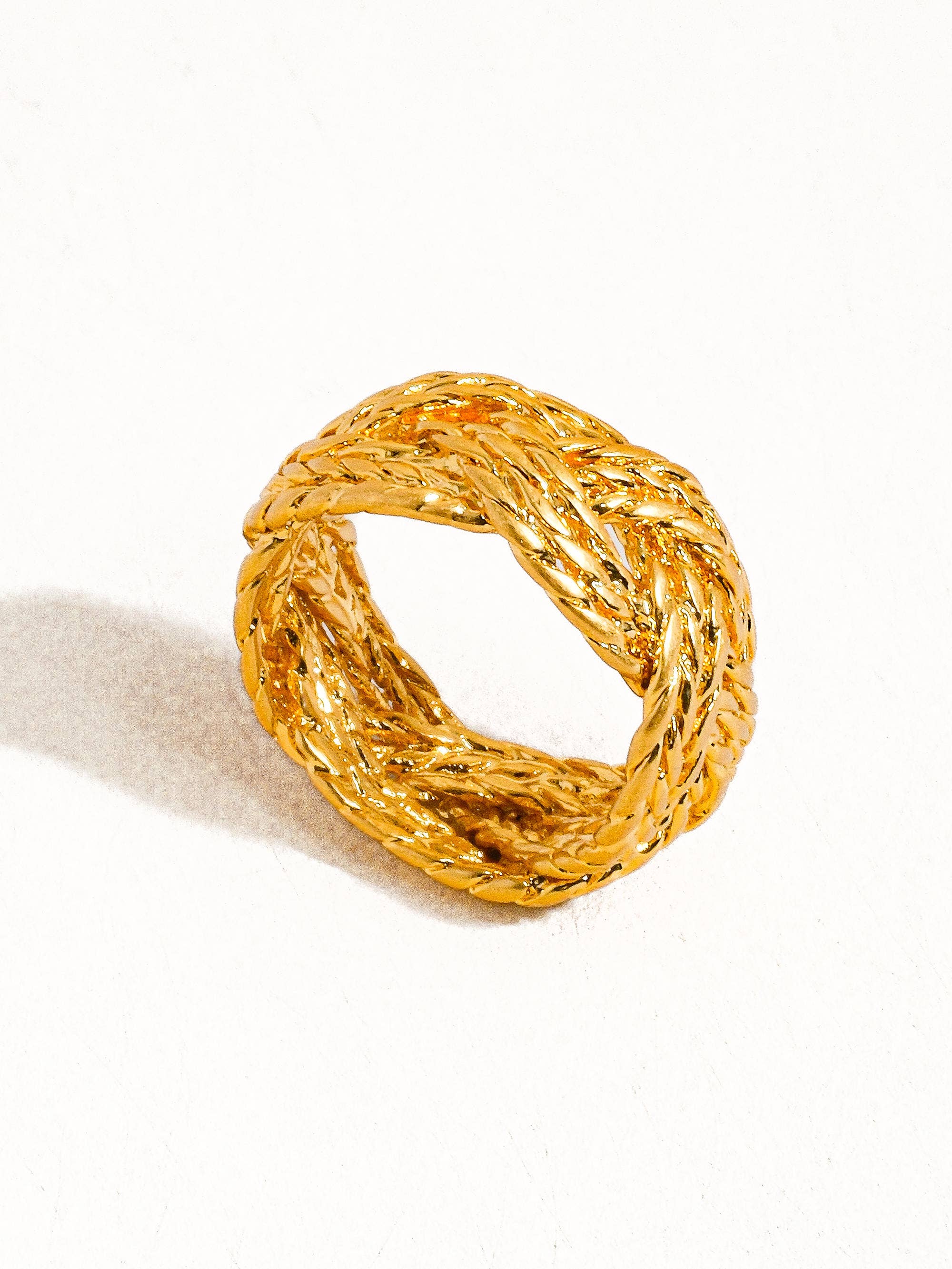 Sculptural vintage-inspired ring with a polished gold twist design, crafted from 18K gold-plated brass. Sized at US 7 (0.682" diameter), this hypoallergenic, water- and tarnish-resistant piece blends timeless charm with everyday wearability.
