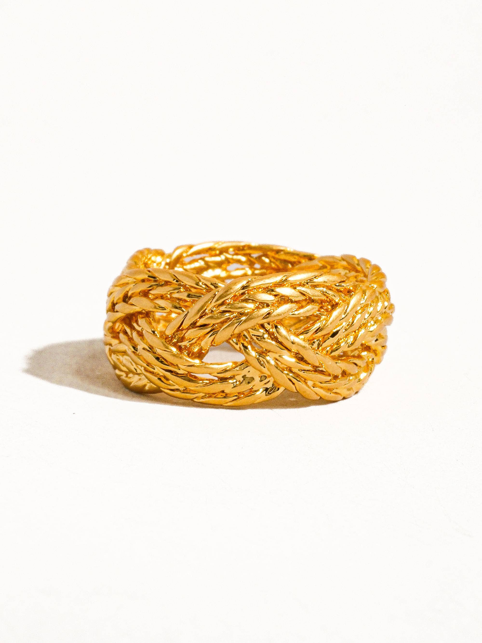 Sculptural vintage-inspired ring with a polished gold twist design, crafted from 18K gold-plated brass. Sized at US 7 (0.682" diameter), this hypoallergenic, water- and tarnish-resistant piece blends timeless charm with everyday wearability.