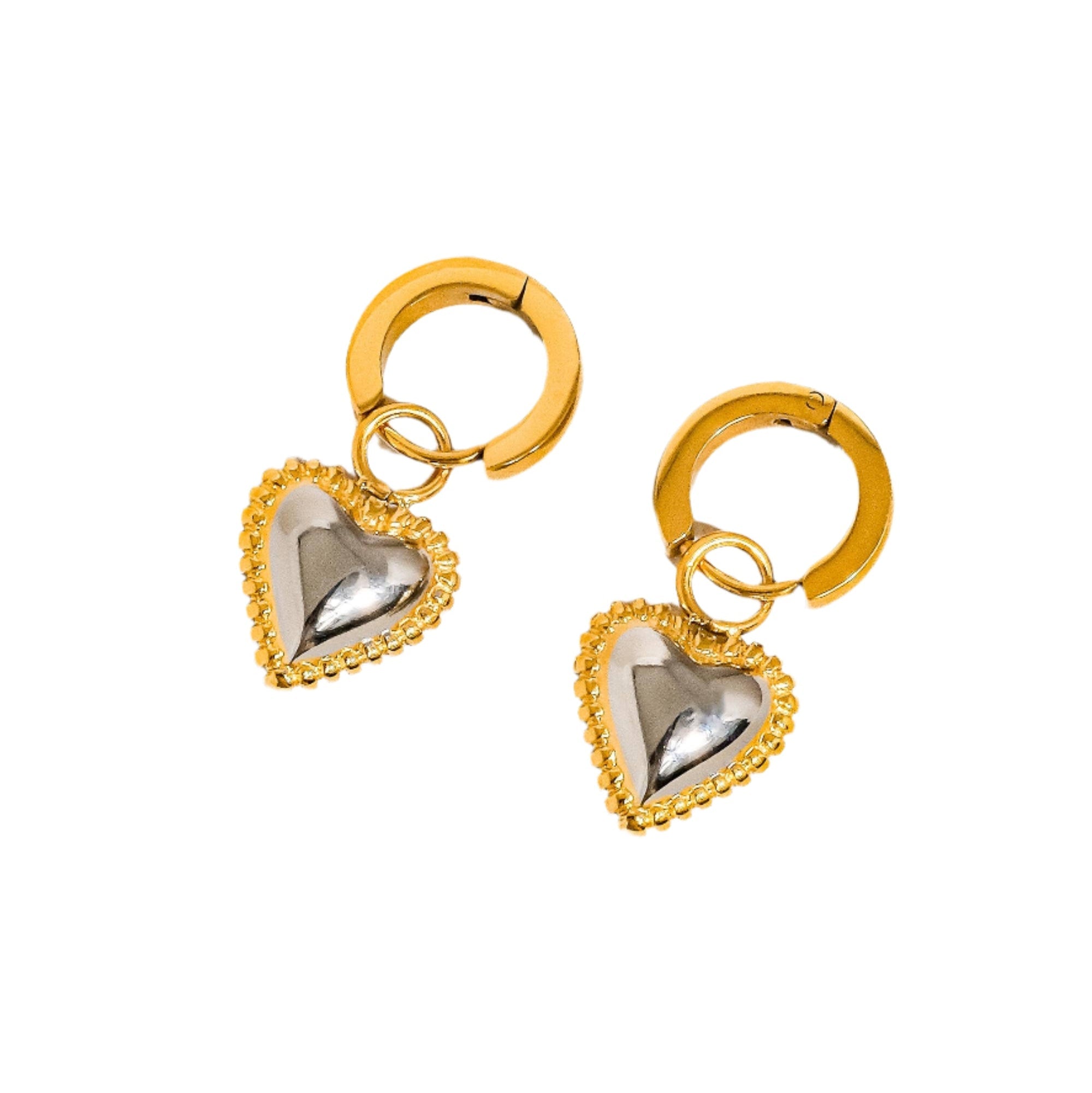 Sculptural heart-shaped earrings in a two-tone gold and silver finish, crafted from 18K gold-plated stainless steel. Measuring 2.82 × 1.30 cm, these hypoallergenic, water- and tarnish-resistant earrings bring a modern romantic touch to any look.