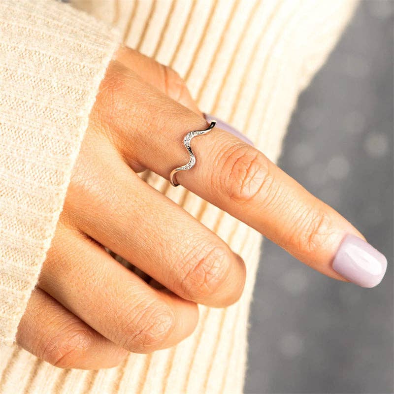 Minimalist wave ring crafted from solid 925 sterling silver with 18K gold plating, featuring a soft wave silhouette accented by dainty cubic zirconia. Hypoallergenic, water- and tarnish-resistant—perfect for capturing the elegance of fluid motion in everyday style.